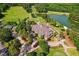 Wonderful aerial view featuring golf course, pond, community clubhouse and surrounding lush greenery at 11475 Club Dr, Chapel Hill, NC 27517