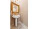 Elegant powder room featuring a pedestal sink with gold fixtures and stylish tile flooring at 11475 Club Dr, Chapel Hill, NC 27517