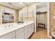 Bathroom with dual sinks, vanity mirror, and a walk-in closet for extra storage at 11475 Club Dr, Chapel Hill, NC 27517