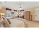 Comfortable bedroom featuring two beds, a ceiling fan, and an armoire with large windows at 11475 Club Dr, Chapel Hill, NC 27517