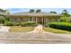 Inviting front exterior showcasing a charming one-story home with stone walkway and lush landscaping at 11475 Club Dr, Chapel Hill, NC 27517