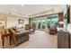 Bright and spacious living room featuring comfortable seating, large windows, and a neutral color palette at 11475 Club Dr, Chapel Hill, NC 27517