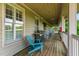 Relaxing covered porch area with outdoor seating and a grill for entertaining at 11475 Club Dr, Chapel Hill, NC 27517