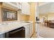 Convenient wet bar featuring white cabinets, a mini fridge, and a microwave oven at 11475 Club Dr, Chapel Hill, NC 27517