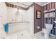 Bathroom with a toilet, white shower stall, striped wallpaper, and accessibility features at 11477 Club Dr, Chapel Hill, NC 27517