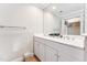 Bathroom featuring a double sink vanity with white cabinets, a large mirror, and a closet at 11477 Club Dr, Chapel Hill, NC 27517