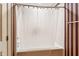 Bathroom with a white bathtub, shower curtain, and striped wallpaper at 11477 Club Dr, Chapel Hill, NC 27517