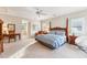 Bedroom with a four-poster bed, ceiling fan, and a sitting area with a desk at 11477 Club Dr, Chapel Hill, NC 27517