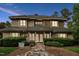 Inviting two-story home featuring manicured landscaping, a stone pathway, and a welcoming entrance at 11477 Club Dr, Chapel Hill, NC 27517