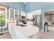 Bright kitchen with white cabinetry, stainless steel appliances, and an island with a sink at 11477 Club Dr, Chapel Hill, NC 27517