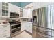 Updated kitchen featuring stainless steel appliances and white cabinetry at 11477 Club Dr, Chapel Hill, NC 27517