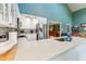 Kitchen with white cabinets, stainless steel appliances, and island overlooking open living area at 11477 Club Dr, Chapel Hill, NC 27517