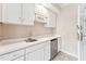 Kitchenette with white cabinets, countertops, a sink, a mini fridge, and a microwave at 11477 Club Dr, Chapel Hill, NC 27517