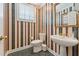 Charming powder room with striped wallpaper, pedestal sink, and traditional fixtures at 11483 Club Dr, Chapel Hill, NC 27517
