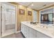 Bright bathroom featuring a double vanity, framed mirror, and a separate water closet at 11483 Club Dr, Chapel Hill, NC 27517