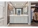 A bathroom with a double vanity, large mirror, and a separate water closet at 11483 Club Dr, Chapel Hill, NC 27517