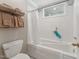 A white bathroom with a shower and bathtub combination and white tile flooring at 11483 Club Dr, Chapel Hill, NC 27517