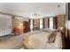 Bright bedroom featuring two beds, a ceiling fan, and multiple windows for natural light at 11483 Club Dr, Chapel Hill, NC 27517