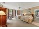 Comfortable bedroom featuring two beds, a ceiling fan, and windows at 11483 Club Dr, Chapel Hill, NC 27517