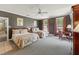 Large bedroom with two beds, a desk, large windows and a neutral color scheme at 11483 Club Dr, Chapel Hill, NC 27517