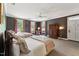 A large bedroom with two beds, a desk and chair, and a large wardrobe at 11483 Club Dr, Chapel Hill, NC 27517