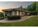 Attractive home featuring a covered porch, lush landscaping, and manicured lawn at 11483 Club Dr, Chapel Hill, NC 27517