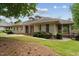Charming single-story home with well-manicured lawn and mature trees at 11483 Club Dr, Chapel Hill, NC 27517