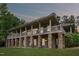 Beautiful home with stone foundation, covered porch, and views of the surrounding landscape at 11483 Club Dr, Chapel Hill, NC 27517