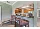 Kitchen area featuring modern appliances, wooden cabinets, and barstool seating for a cozy, connected space at 11483 Club Dr, Chapel Hill, NC 27517