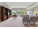 Bright living room with large windows, elegant furniture, and a built-in bookcase for a sophisticated touch at 11483 Club Dr, Chapel Hill, NC 27517