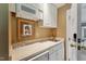 Convenient wet bar featuring a sink, storage, and microwave, perfect for hosting and entertaining guests at 11483 Club Dr, Chapel Hill, NC 27517