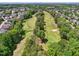 Scenic aerial view of the golf course with lush green fairways surrounded by trees and homes at 11916 Deneb Ct, Raleigh, NC 27614