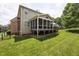 Spacious backyard featuring a screened-in porch, wooden deck, and lush green lawn, perfect for outdoor enjoyment at 11916 Deneb Ct, Raleigh, NC 27614