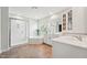 Bright bathroom with a glass shower, soaking tub, double vanity, and modern fixtures at 11916 Deneb Ct, Raleigh, NC 27614