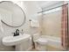 Clean bathroom with a white toilet, sink, modern faucet, and a shower-tub combination at 11916 Deneb Ct, Raleigh, NC 27614