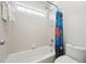 Bathroom with a tub, tiled walls, and a window at 11916 Deneb Ct, Raleigh, NC 27614