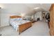 Spacious bonus room with a large bed, sitting area with sofa and chair, and neutral colored carpet at 11916 Deneb Ct, Raleigh, NC 27614