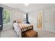 Bedroom featuring carpeted floors, a window, and a wooden bed frame with decorative pillows at 11916 Deneb Ct, Raleigh, NC 27614
