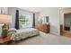 Bright bedroom featuring a twin bed, natural light from a window with seat, and a wooden dresser at 11916 Deneb Ct, Raleigh, NC 27614