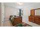 Bedroom showcasing carpeted floors, a window, and a wooden bed frame and dresser at 11916 Deneb Ct, Raleigh, NC 27614