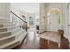 Inviting foyer with hardwood floors, staircase, and large windows creating a bright, open entrance to the home at 11916 Deneb Ct, Raleigh, NC 27614