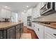 Modern kitchen featuring an island, stainless steel appliances, and sleek white cabinets at 11916 Deneb Ct, Raleigh, NC 27614