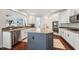 This open-concept kitchen is highlighted by a kitchen island with a sink and stainless steel appliances at 11916 Deneb Ct, Raleigh, NC 27614