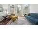 Stylish living room featuring large windows, hardwood floors, and a comfortable seating arrangement at 11916 Deneb Ct, Raleigh, NC 27614