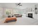 Bright living room features a cozy fireplace, built-in shelves, and abundant natural light from large windows at 11916 Deneb Ct, Raleigh, NC 27614