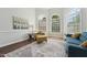 Cozy living room with hardwood floors, bright windows, a painting, and comfortable seating creating a relaxing atmosphere at 11916 Deneb Ct, Raleigh, NC 27614