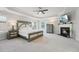 Comfortable main bedroom features a tray ceiling, fireplace, and soft carpeting, offering a cozy retreat at 11916 Deneb Ct, Raleigh, NC 27614