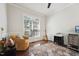 Office space with a chair, guitar, dark wood floors, a patterned rug, and natural light at 11916 Deneb Ct, Raleigh, NC 27614