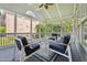 Relaxing screened porch featuring comfortable seating and a view of the landscaped backyard and surrounding neighborhood at 11916 Deneb Ct, Raleigh, NC 27614