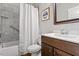 Cozy bathroom featuring a shower/tub combo, neutral tile, and a vanity with storage at 12 Beacon Ridge Blvd, Chapel Hill, NC 27516
